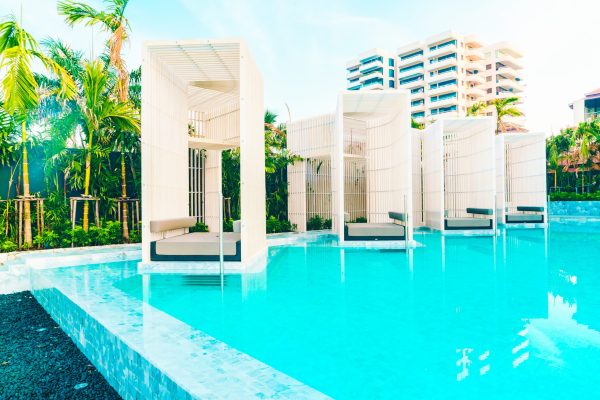 Beautiful luxury hotel swimming pool with umbrella and beach chair - Vintage Filter effect